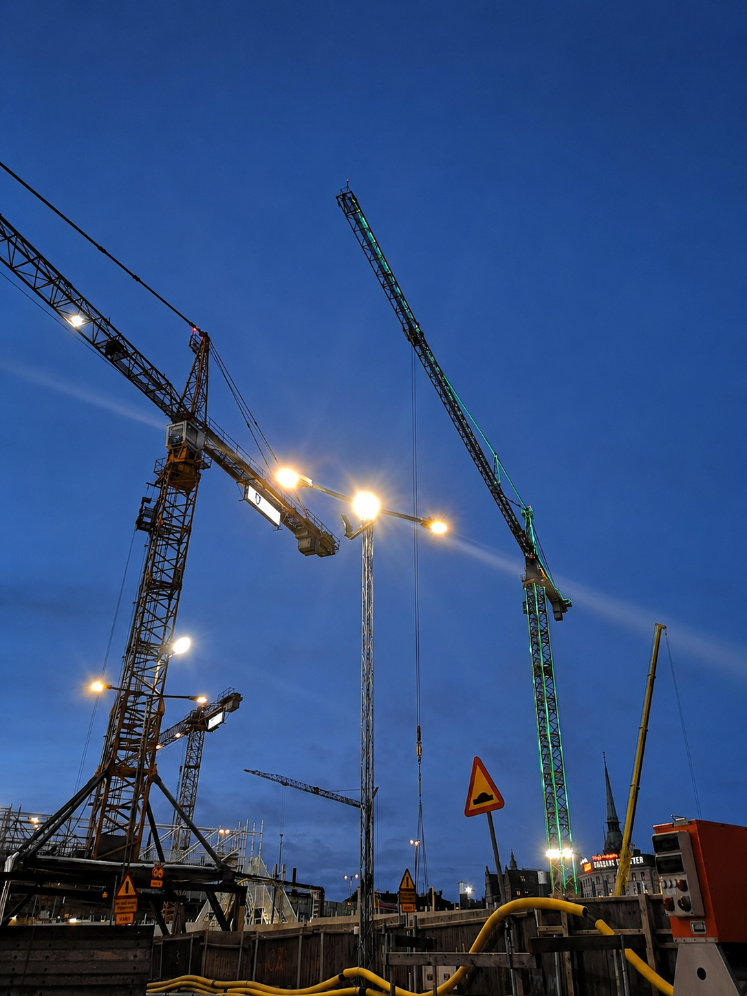 Upplysta tornkranar vid Slussen en kväll